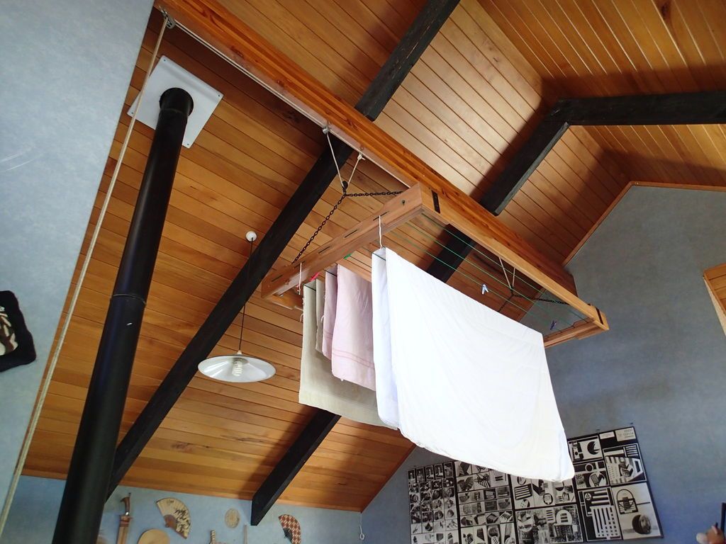 Mount the pulley controlled rack to a ceiling to dry clothes indoors.