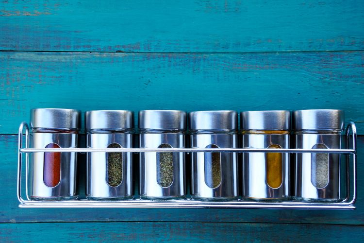 Wall mounted spice racks can help organize spices in a small kitchen