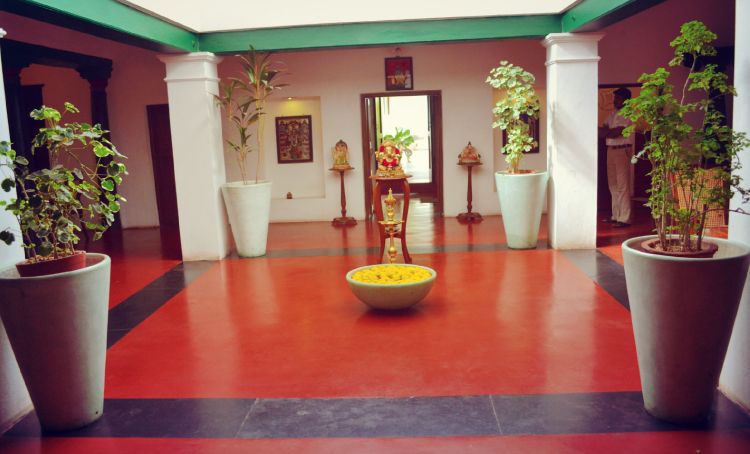red oxide flooring-courtyard-golden idols-potted plants