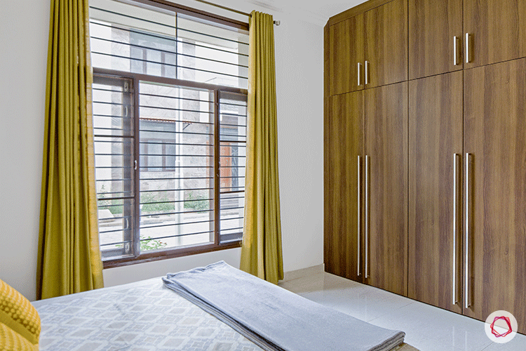 wooden-wardrobe-in-bedroom-with-yellow-curtains