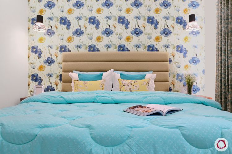 a-bedroom-with-blue-and-yellow-floral-wallpaper
