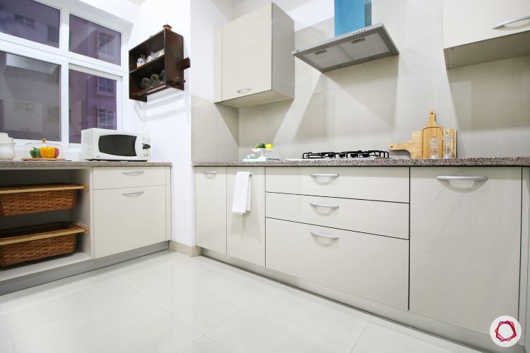 a-kitchen-with-white-cabinets-and-a-microwave-oven