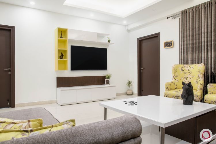 a-living-room-with-yellow-furniture-and-a-tv