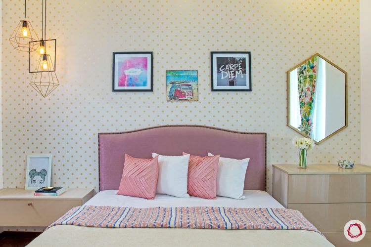 daughter's bedroom-salmon pink headboard-gold polka dotted wallpaper-hexagonal mirror