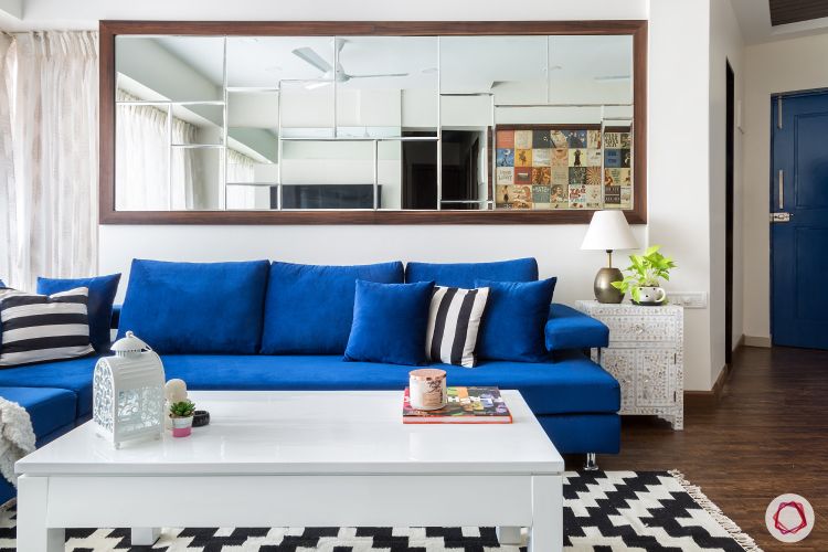 parineeti chopra-blue-sofa-mirror-coffee-table-white-rug-wooden-floor