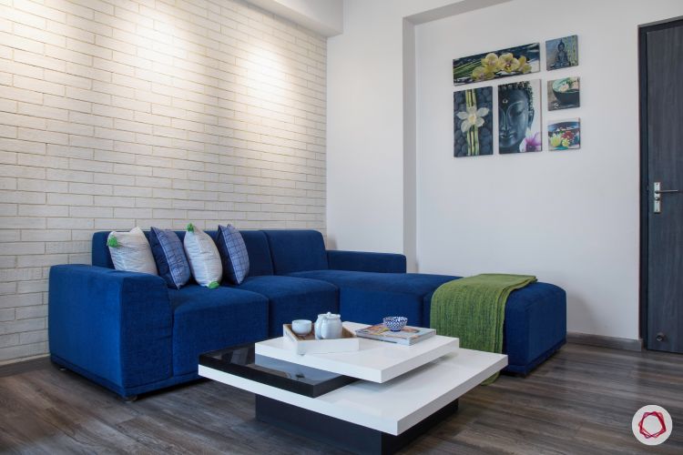 New house design-entertainment room-blue sofa-white exposed brick accent wall