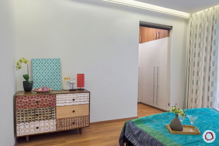 white-wall-bedroom-with-antique-storage-cupboard