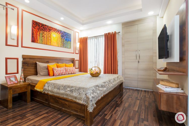 top interior designer master bedroom featuring trims, wooden tones and colourful furnishings