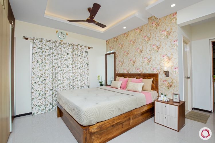 interior master bedroom with wood furniture and floral wallpaper