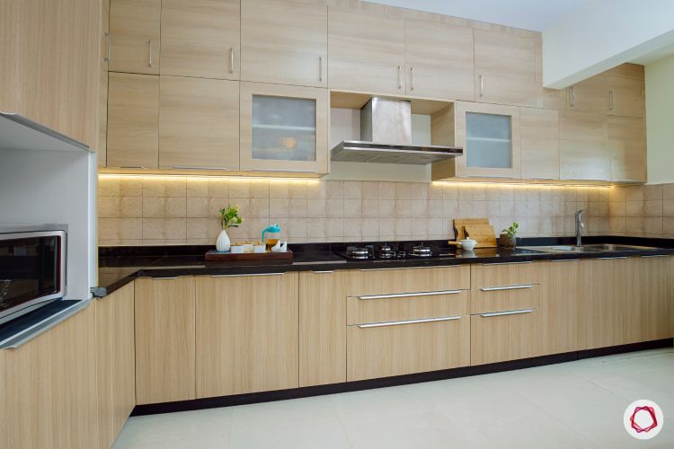 interior of kitchen in acacia finish with lots of storage