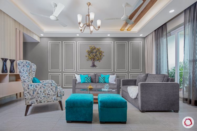 3bhk flat_living room-grey-wall-white-trims-blue-ottomans-chairs-sofas