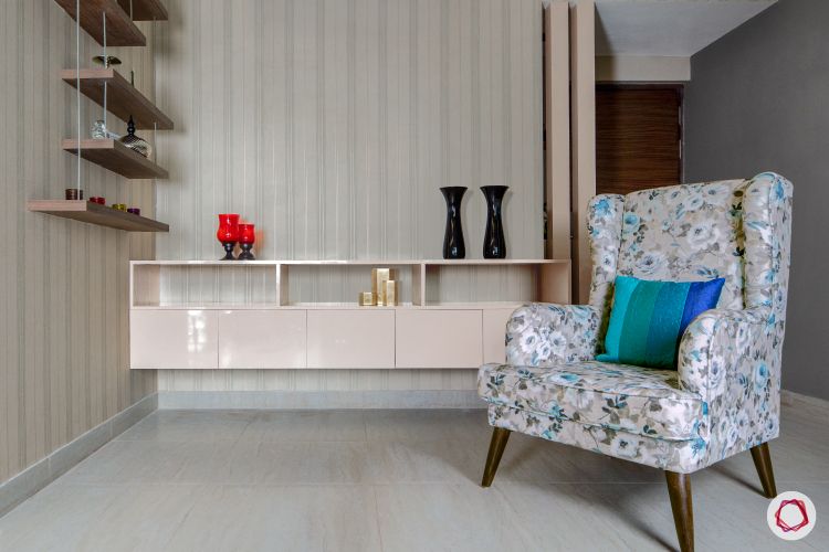 3bhk flat_living room-floral-armchair-shelf-wallpaper