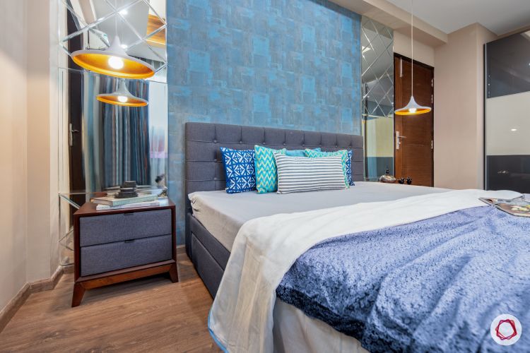 master-bedroom-blue-wall-mirror-panel-light-fixture-bed-sidetable-wooden-floor