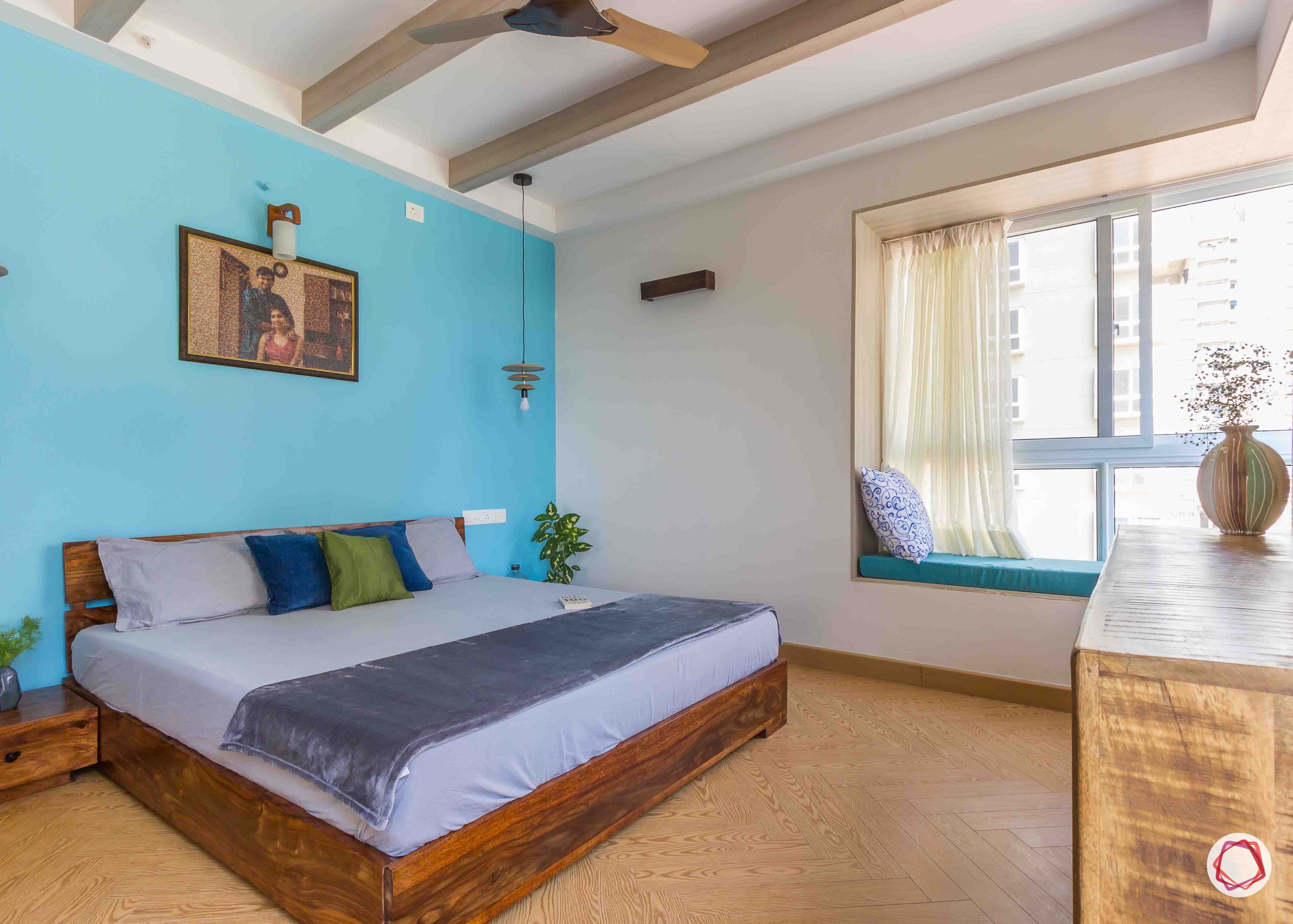 master bedroom-blue-wall-bed-window-seat