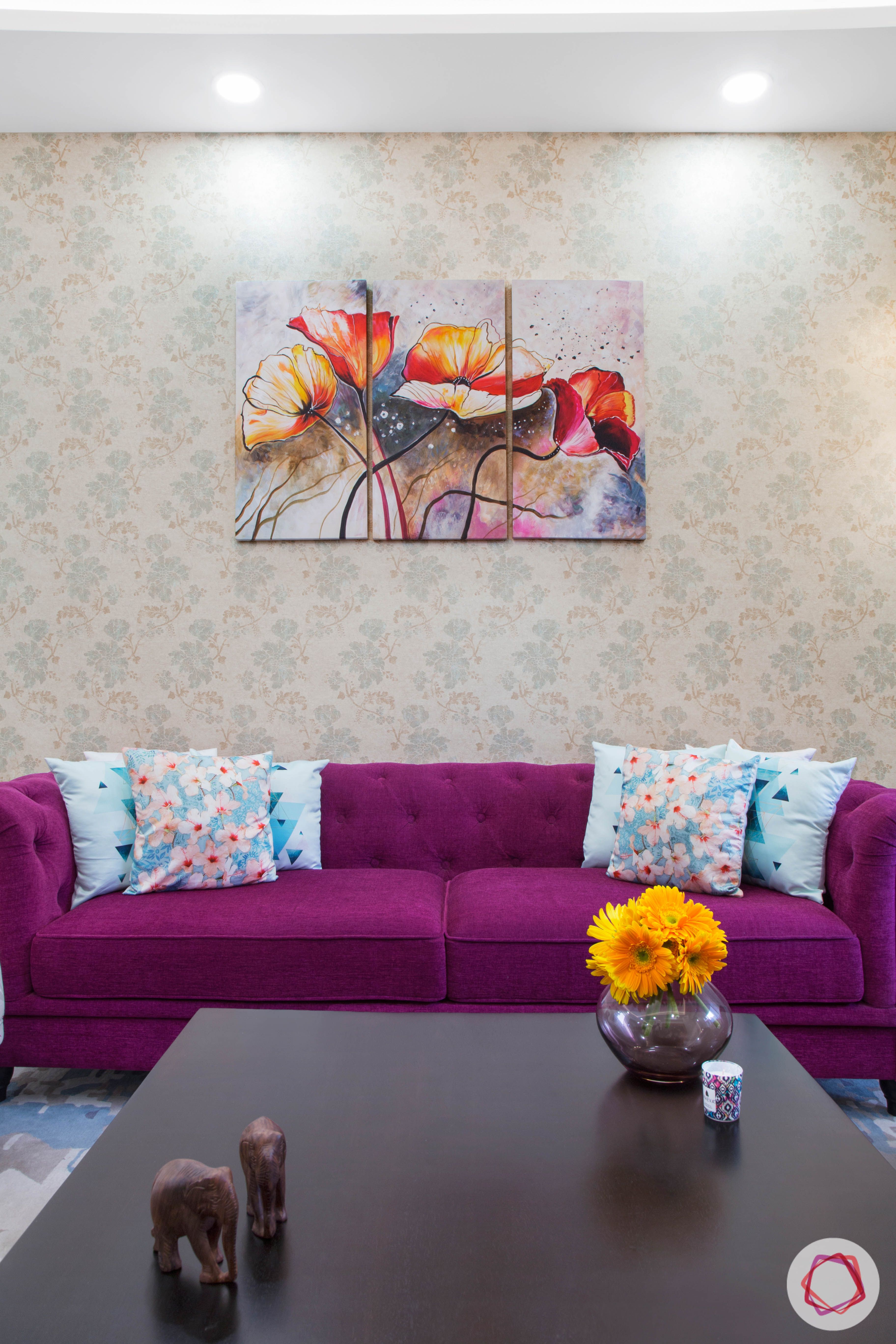 Cleo county noida_purple colour sofa and printed wallpaper