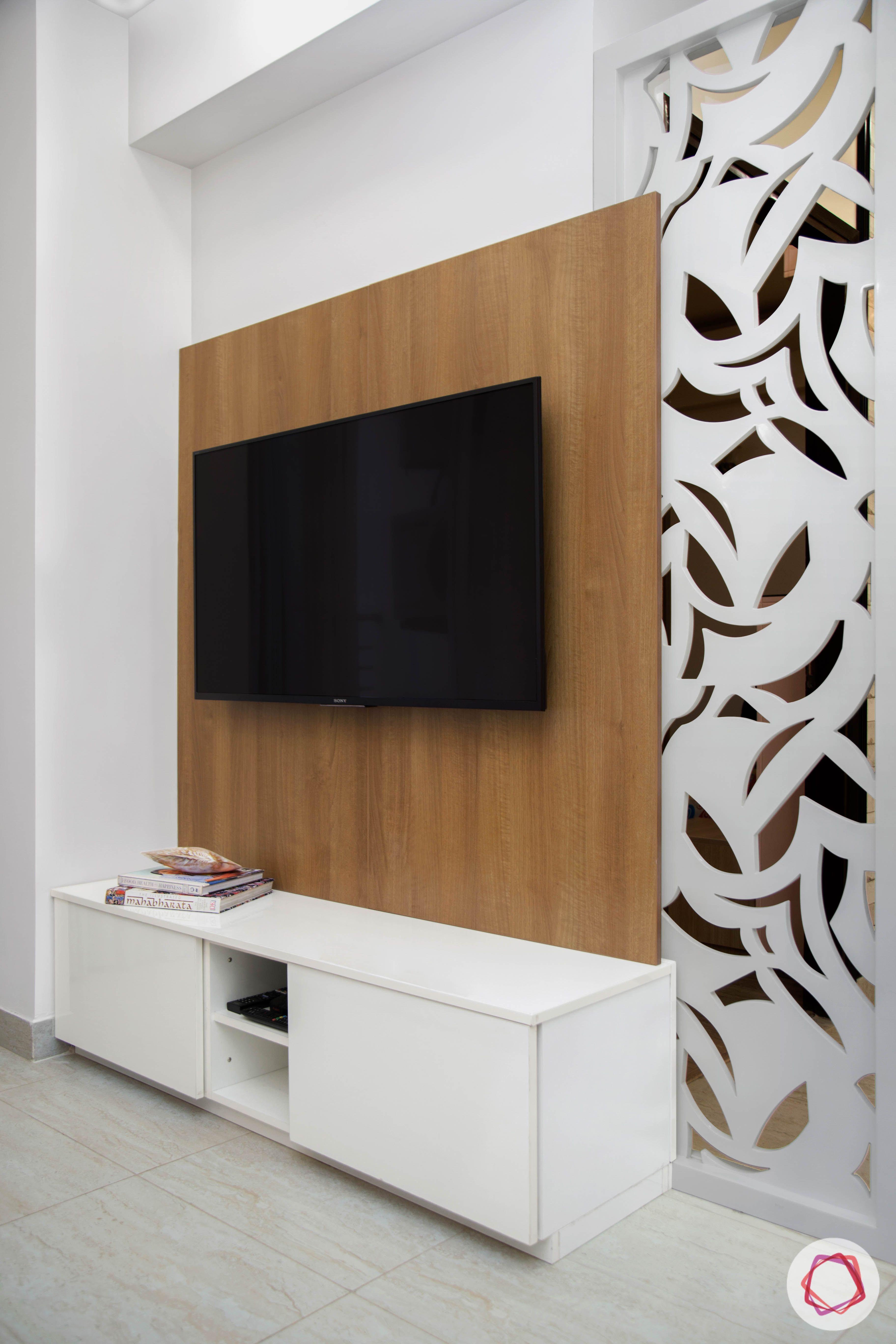 Cleo county noida_living room with laminate tv unit and jaali divider