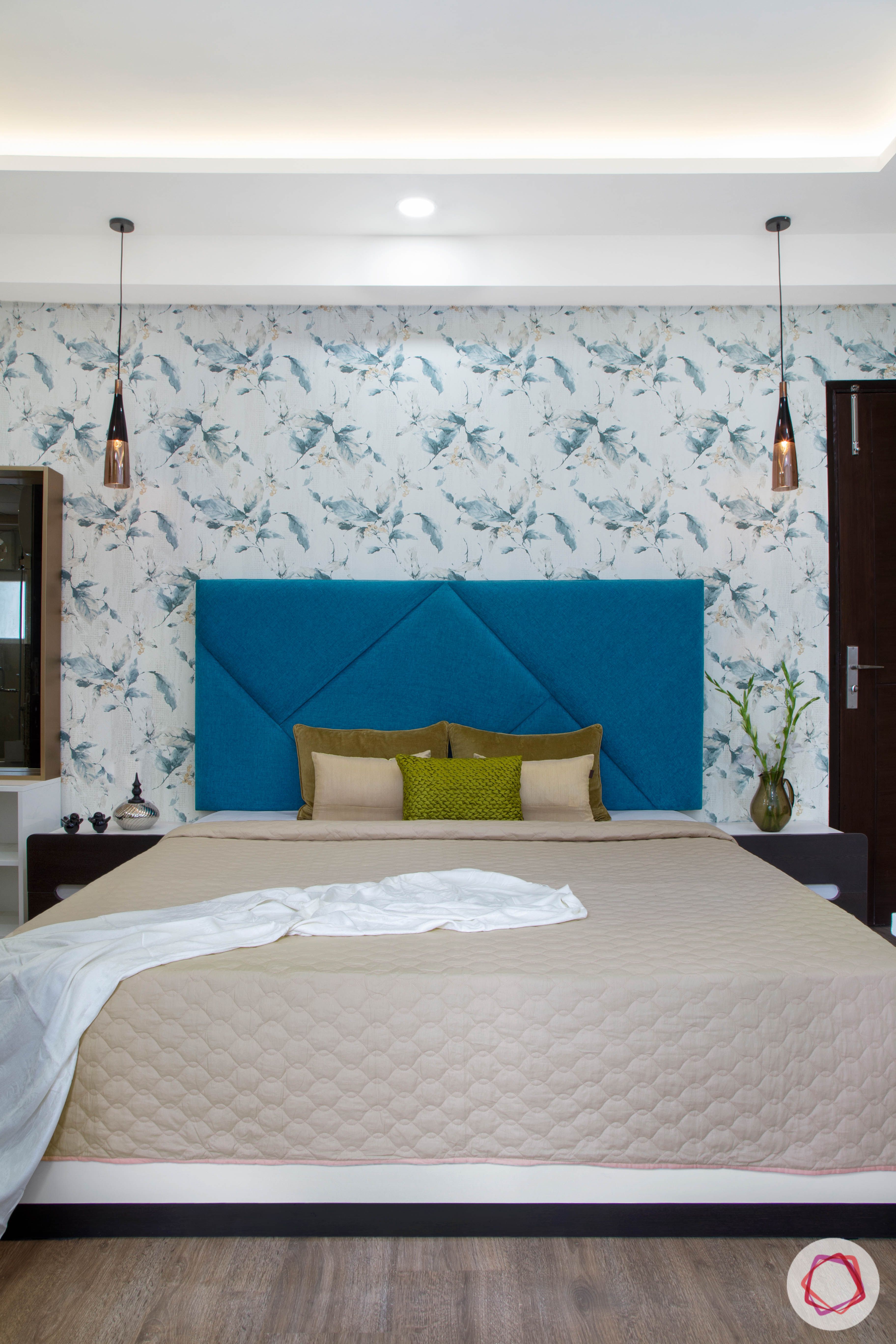 Cleo county noida_master bedroom with blue headboard on white bed