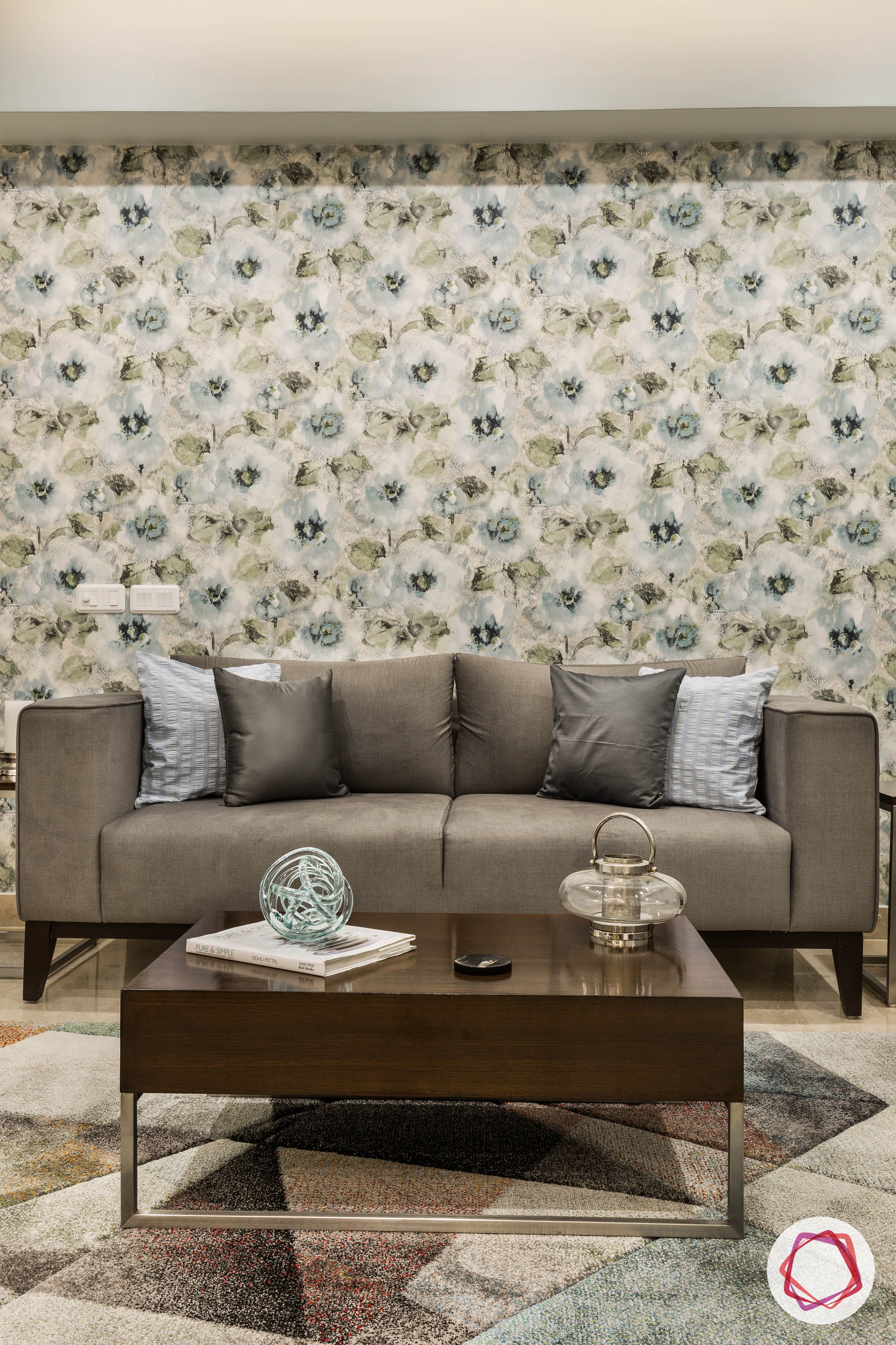 flat interior design-floral-living room-grey sofa-floral wallpaper-coffee table-accent patterned rug
