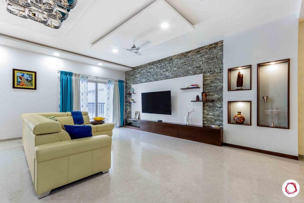 sobha forest view-living room-beige sofa-tv unit-stone wall cladding-wall niches