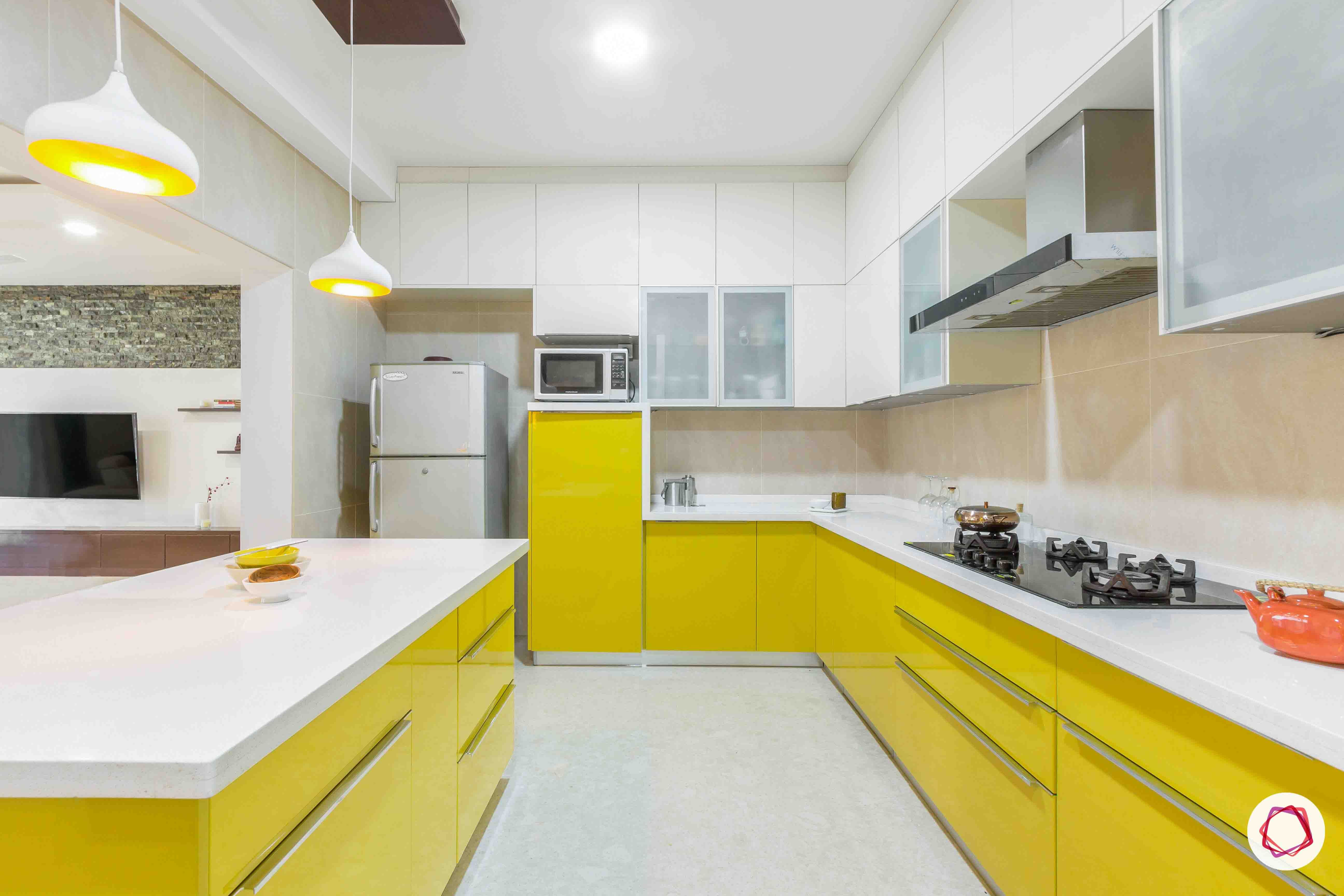 sobha forest view-modular kitchen design-yellow cabinets-lofts-breakfast counter-pendant lights