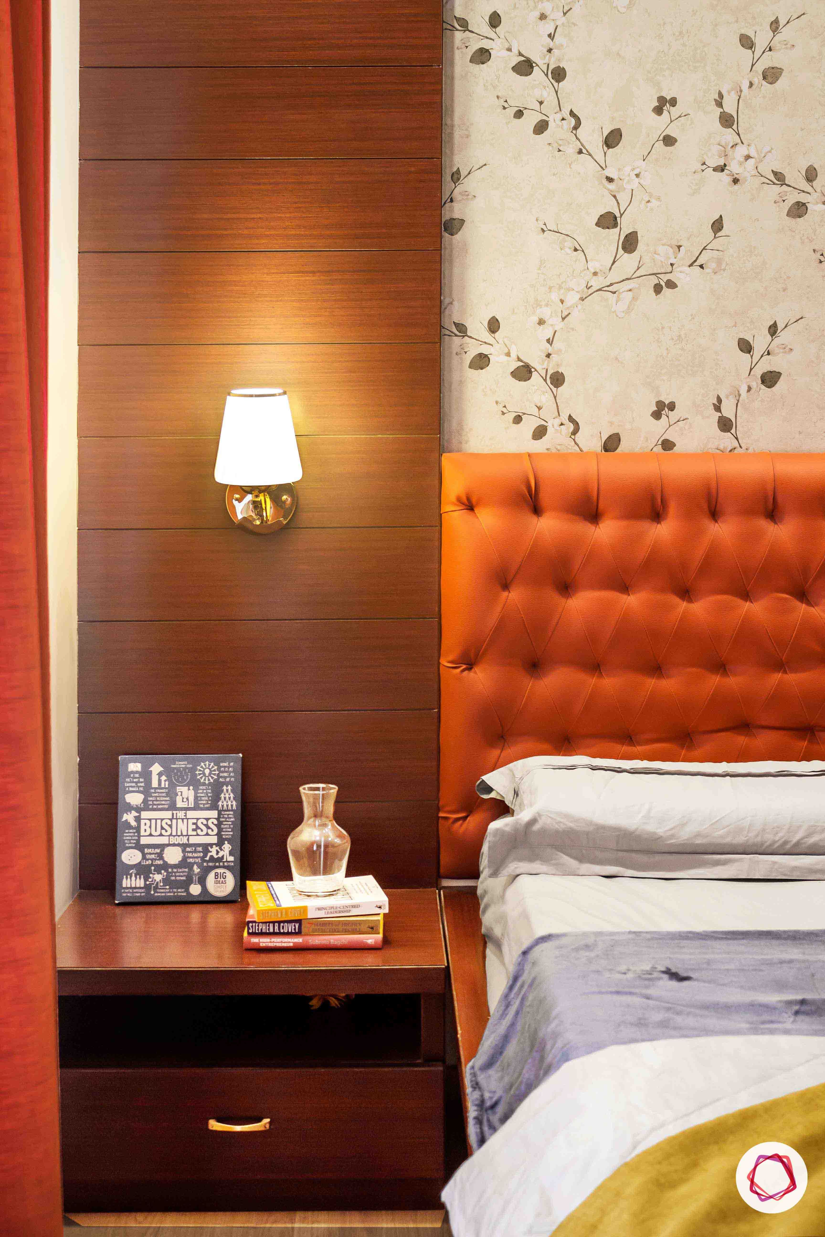sobha forest view-master bedroom-rust orange-wooden tones-floral wallpaper-veneer panel-lampshade