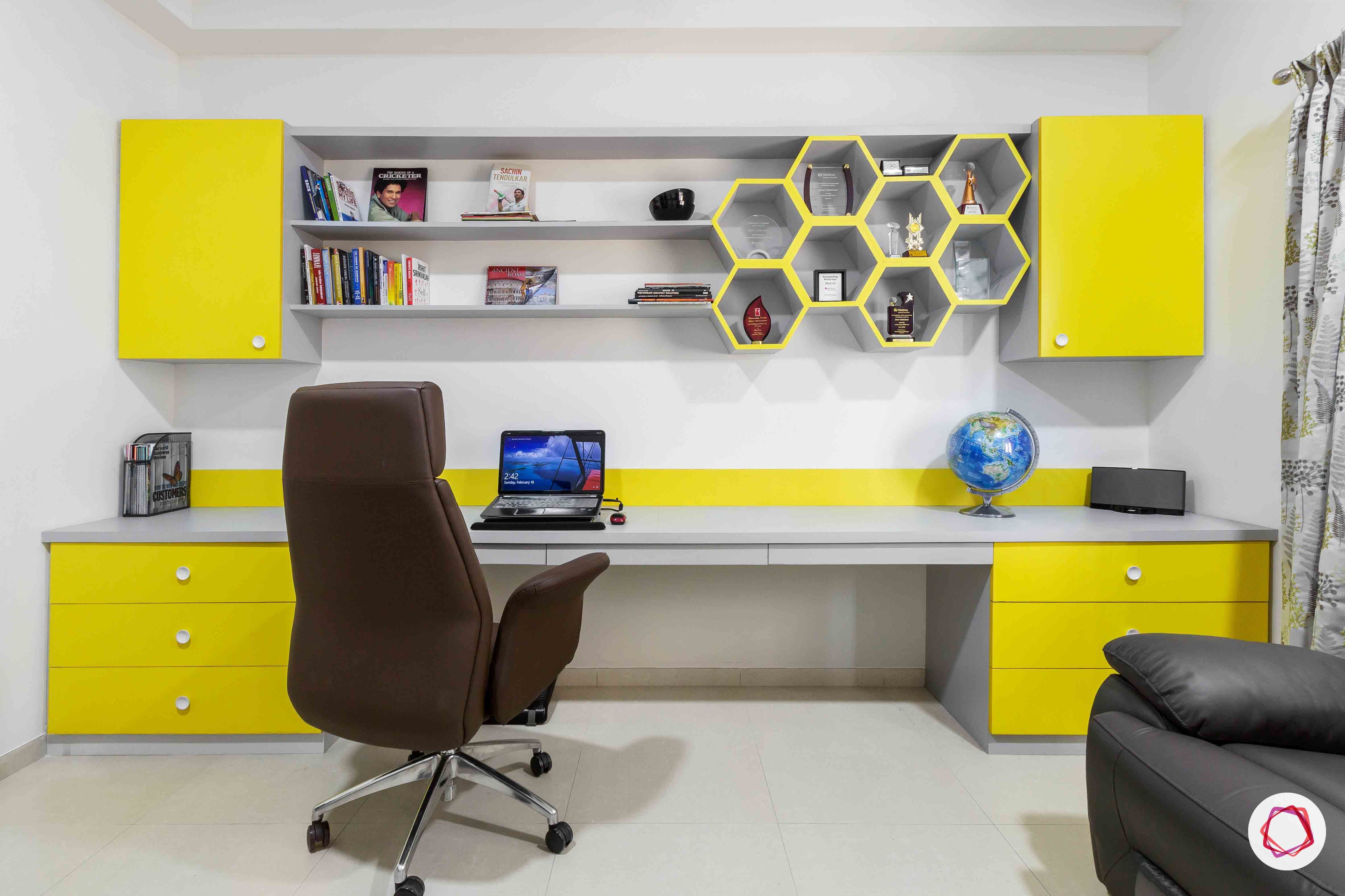 sobha forest view-study room-big study table-wall cabinets-yellow colour shelves