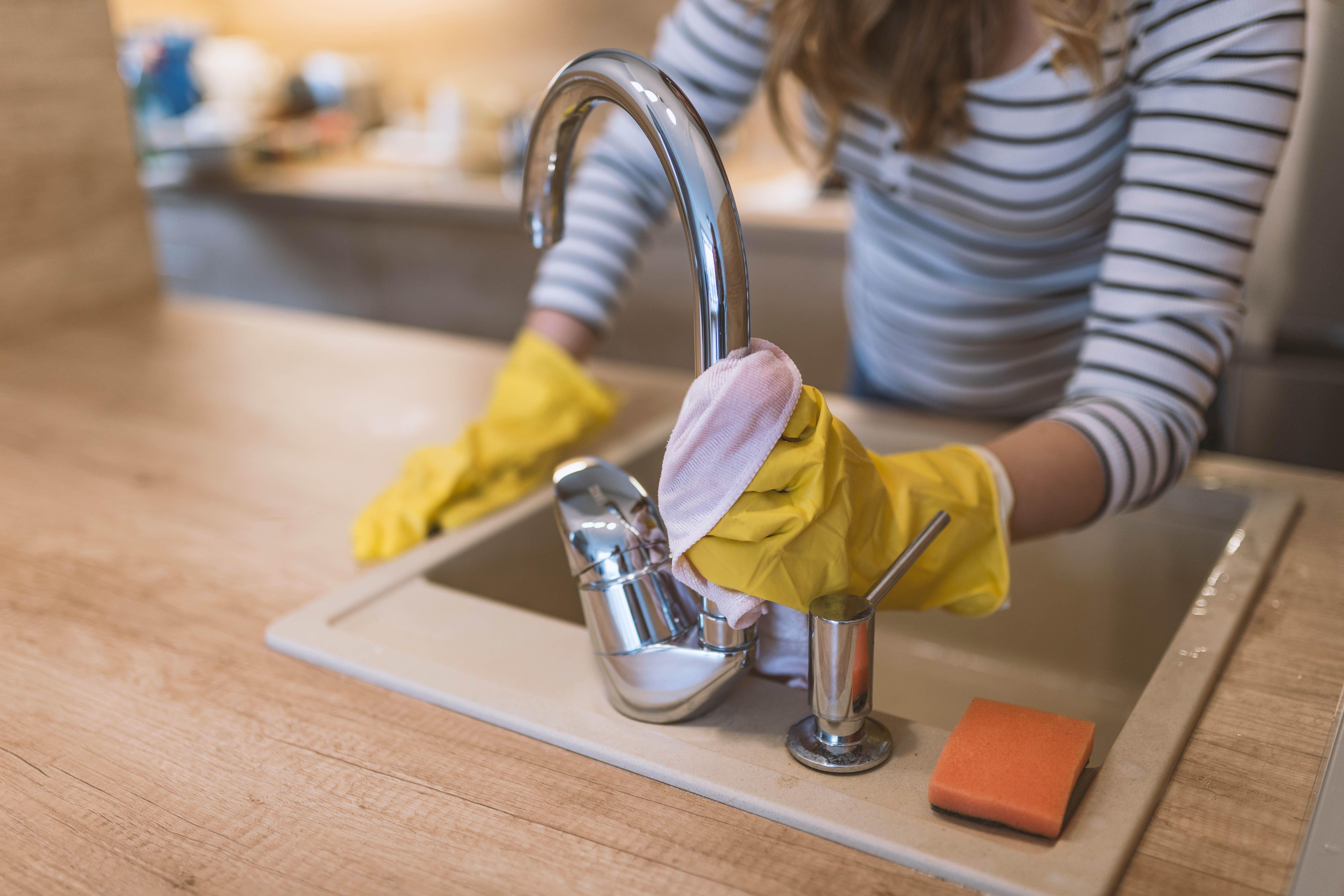 housekeeping-checklist-kitchen-wiping-the-tap-sink-rubber-gloves