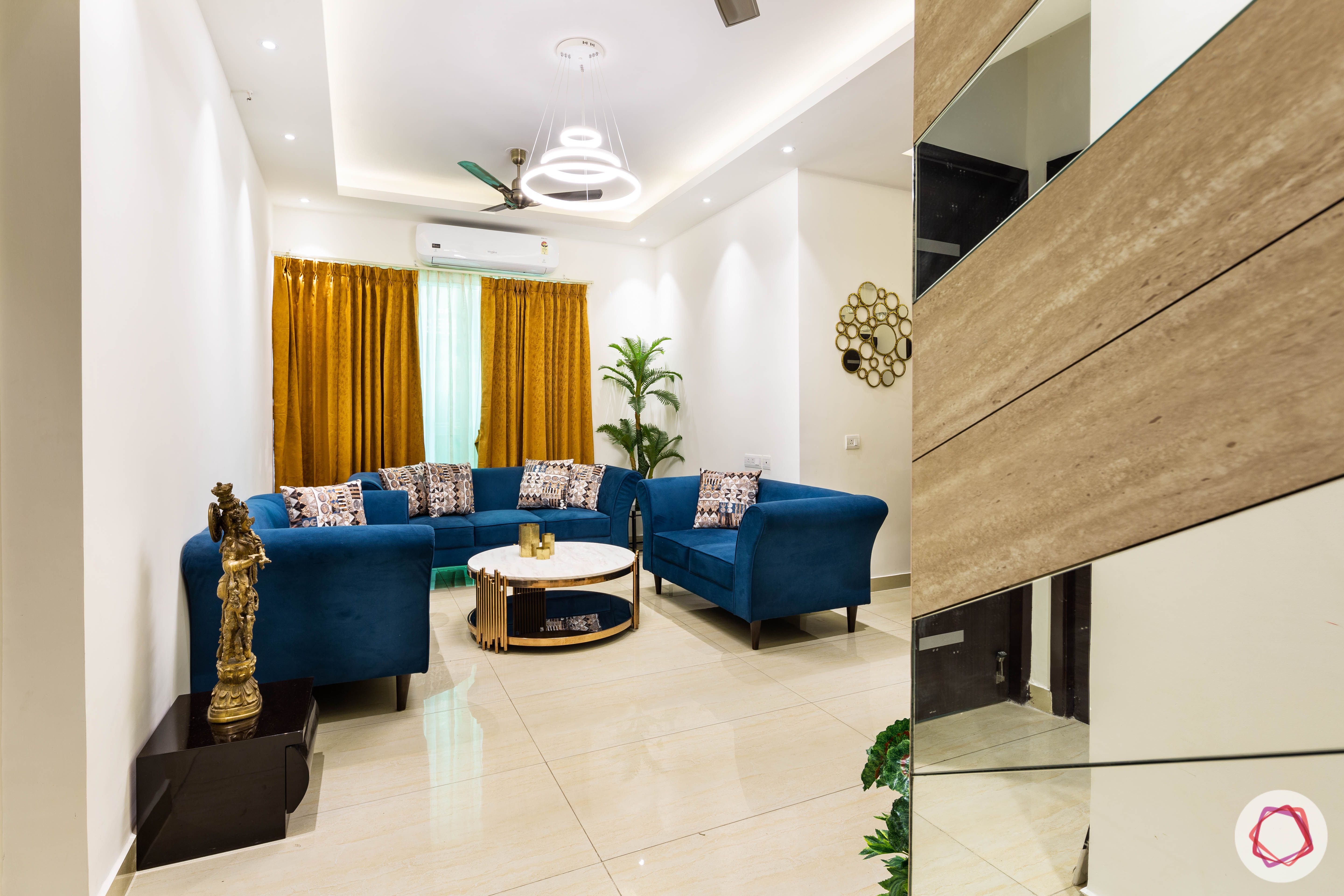 3 bhk flat-living room-entrance-blue sofas-yellow curtains