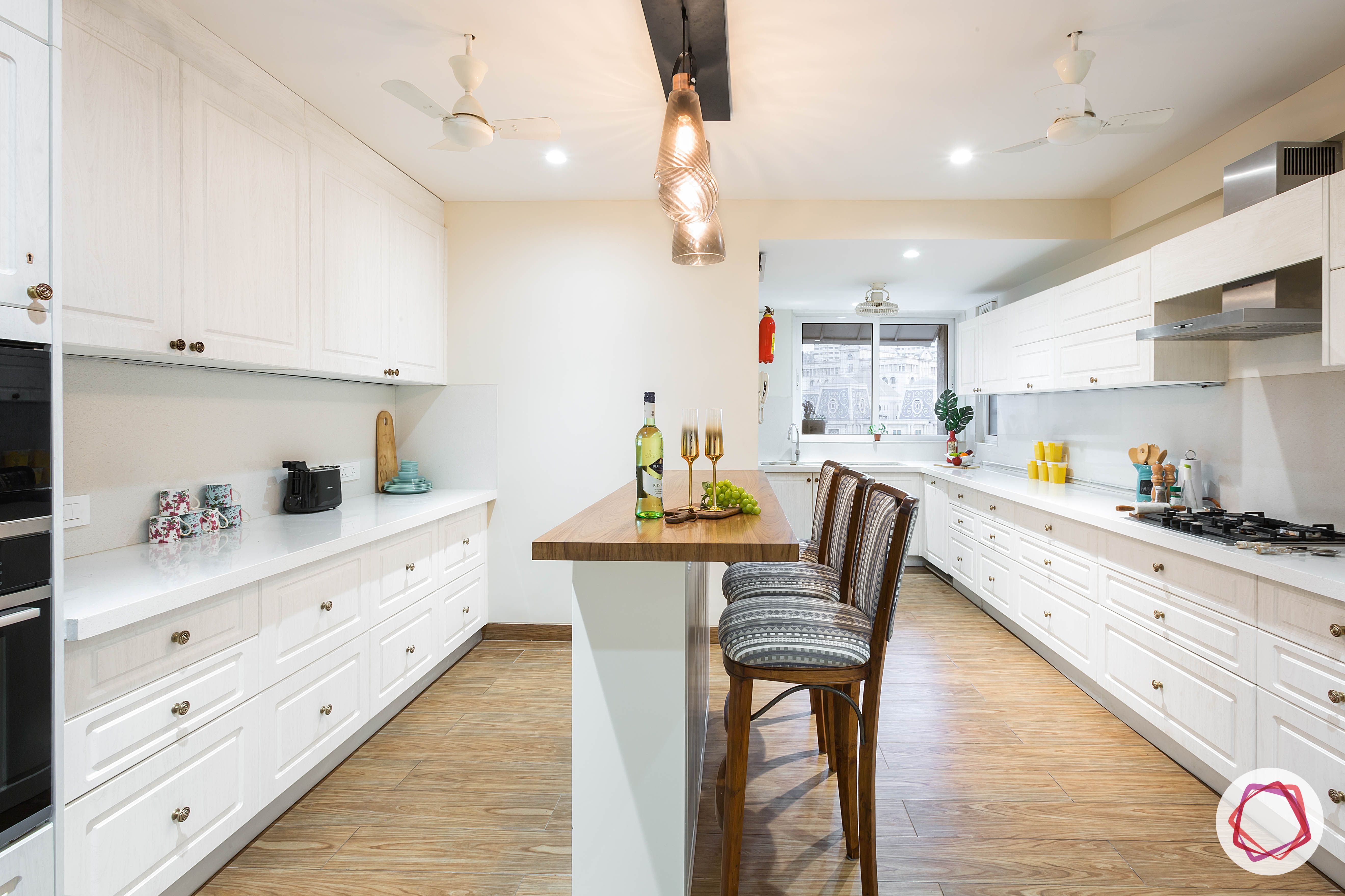 4bhk house plan-white kitchen designs-quartz countertops-white countertops-island kitchen designs-breakfast counter in kitchen-wooden flooring designs