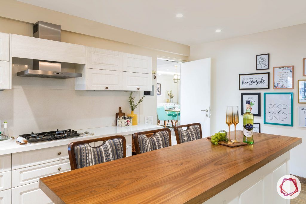 4bhk house plan-white kitchen designs-quartz countertops-white countertops-island kitchen designs-breakfast counter in kitchen-wooden breakfast counter-kitchen island counter