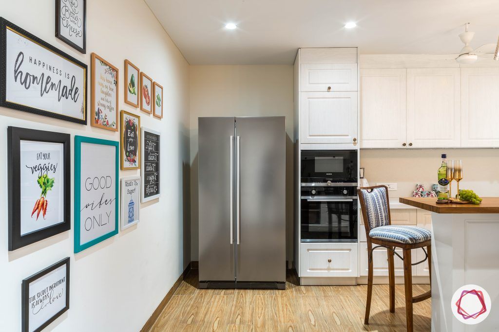 4bhk house plan-white kitchen designs-quartz countertops-white countertops-island kitchen designs-breakfast counter in kitchen-wooden flooring designs-kitchen gallery wall