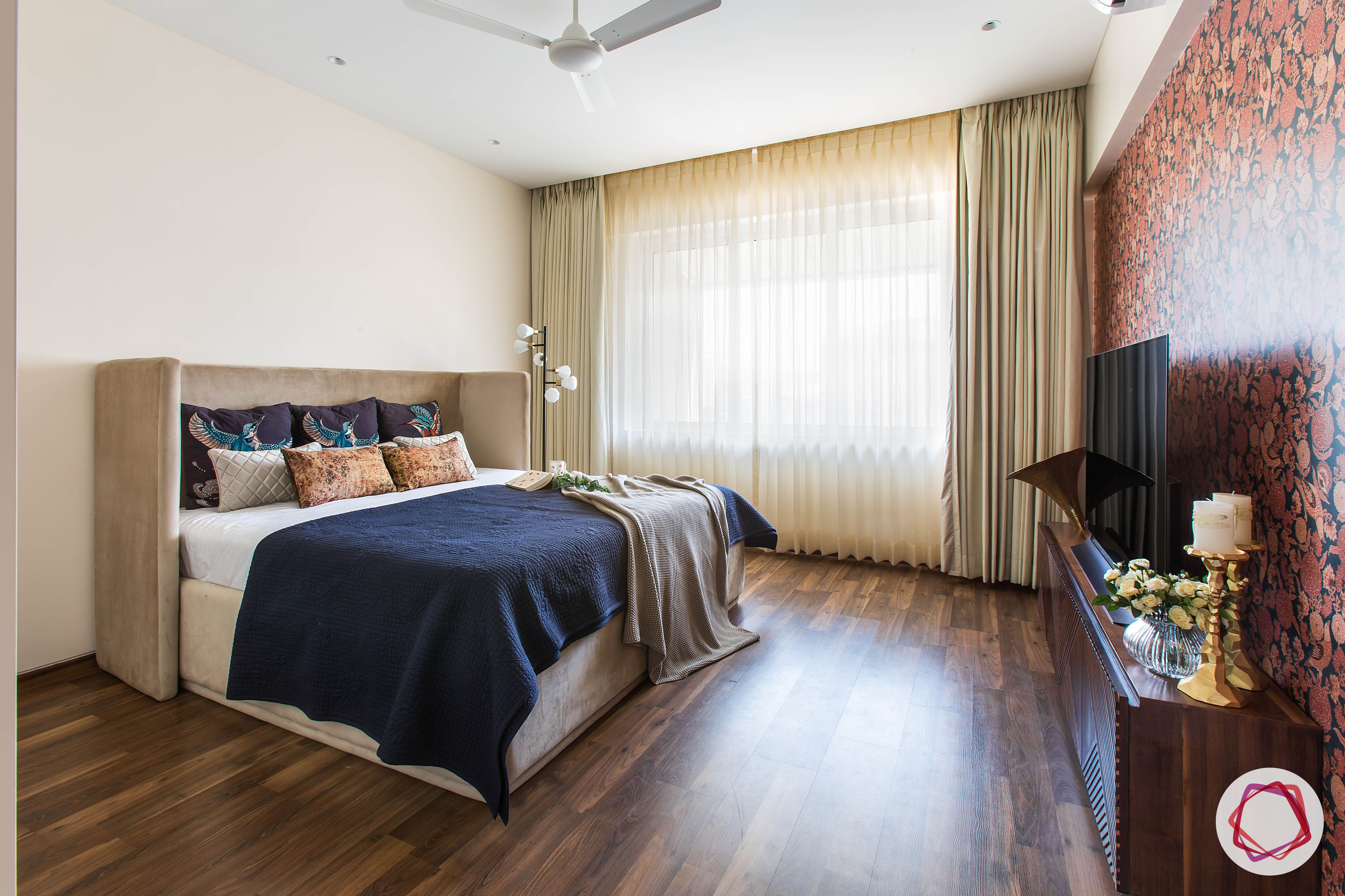 4bhk house plan-guest room designs-upholstered bed-floral wallpaper-wooden flooring 
