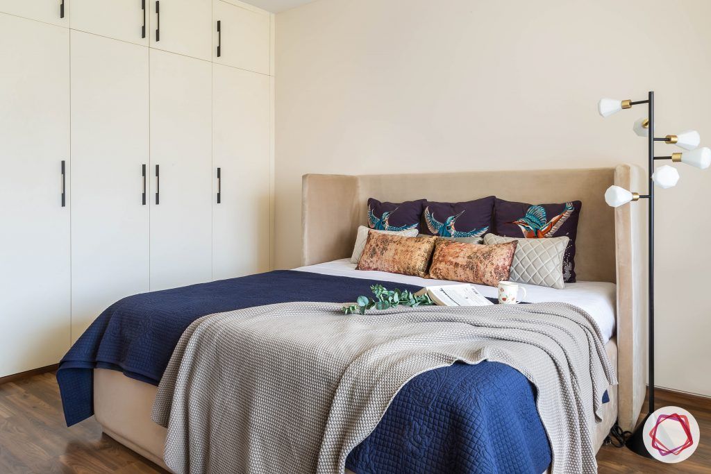 4bhk house plan-guest room designs-upholstered bed-wingback bed-wooden flooring-white wardrobes