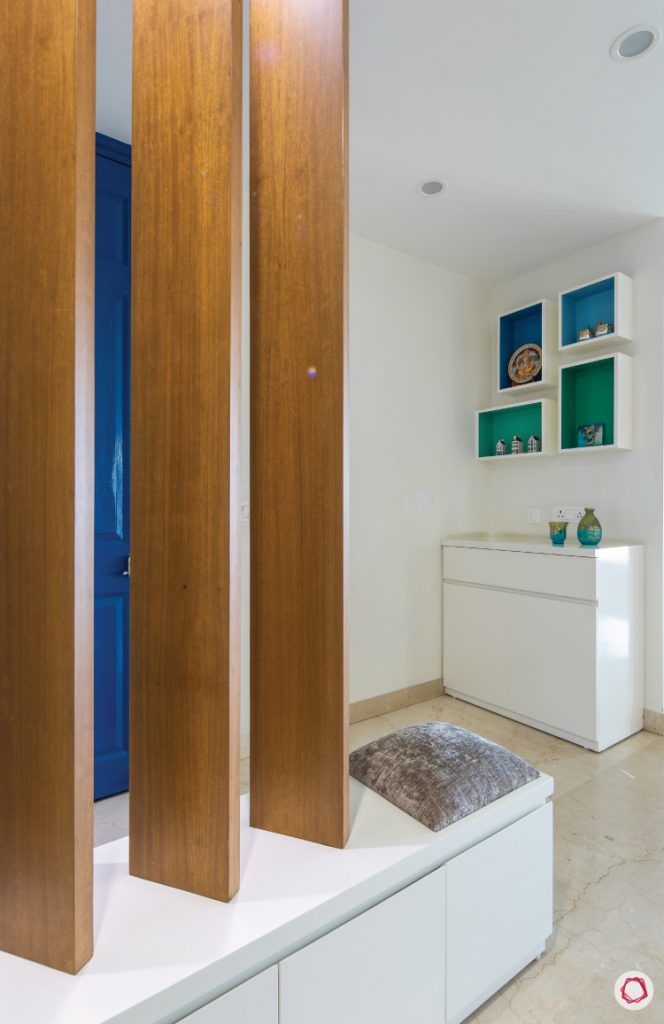 flat-in-faridabad-entrance-foyer-wooden-rafters-storage-cabinet-shelves-white-seating