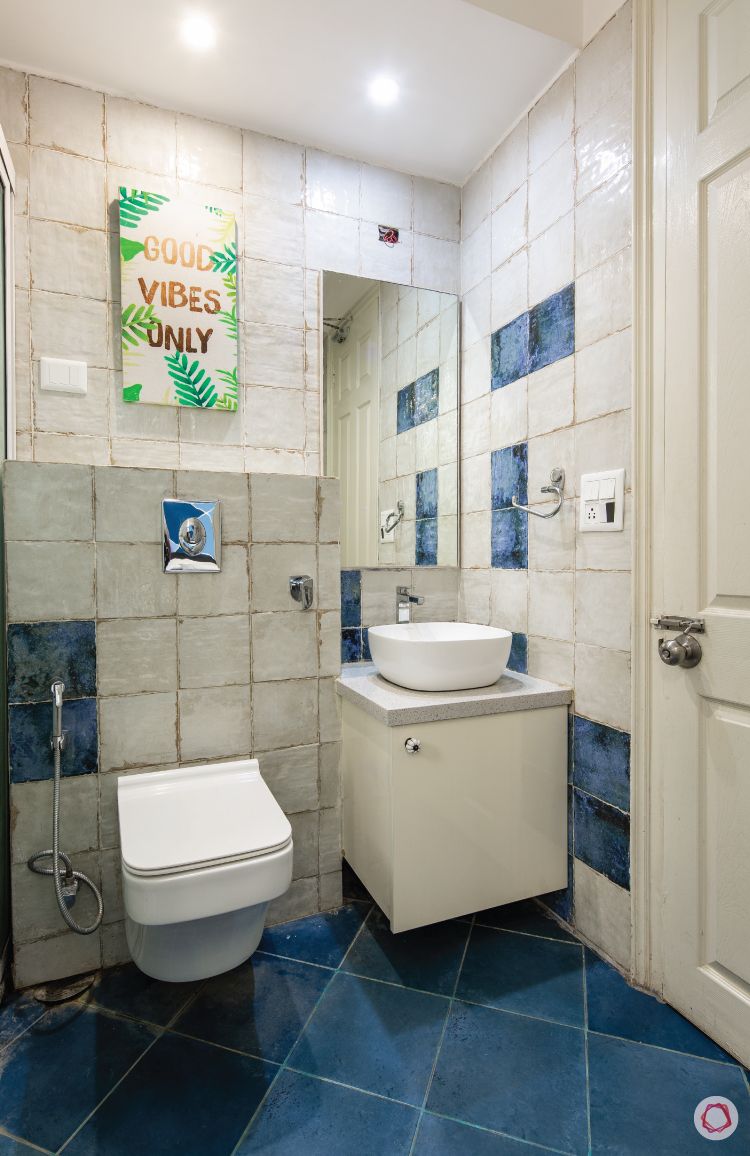 flat-in-faridabad-bathroom-blue-white-tiles-vanity-mirror-sink-cabinet
