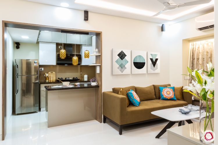 living-room-brown-sofa-wall-art-kitchen-false-ceiling
