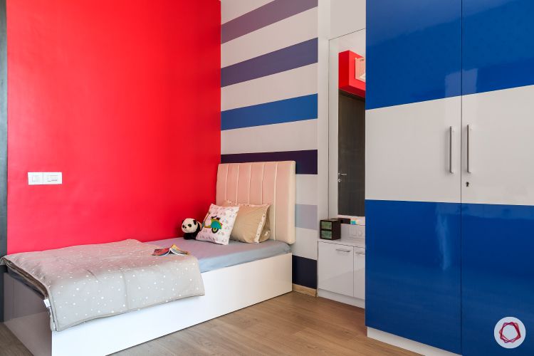 kids room-bright colours-red wall-striped wall-blue wardrobe
