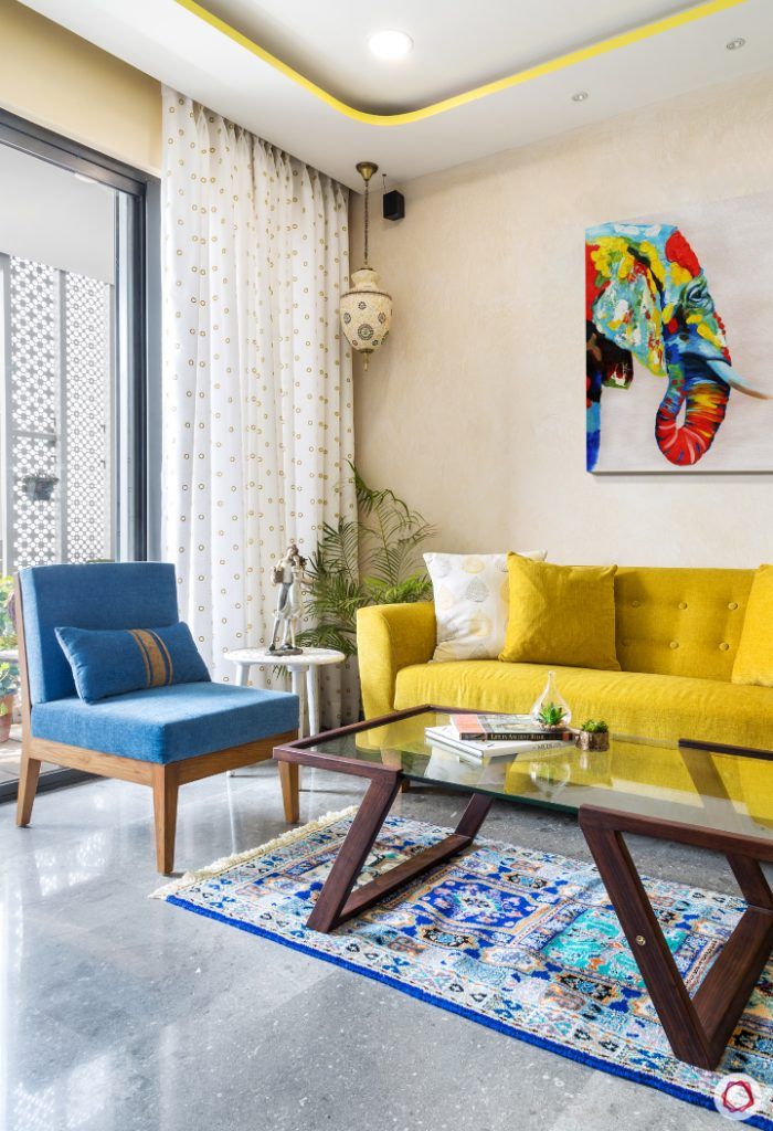 living-room-yellow-sofa-blue-chair-accent-light-stucco-paint
