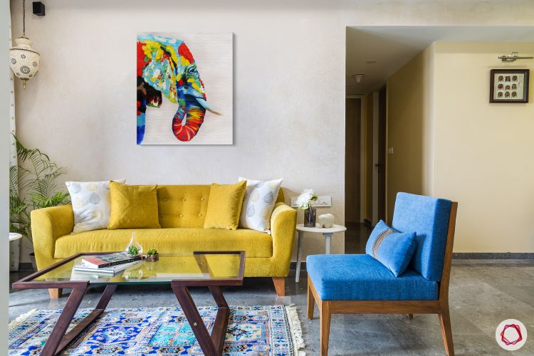 living-room-yellow-sofa-blue-chair-blue-rug-wooden-glass-table
