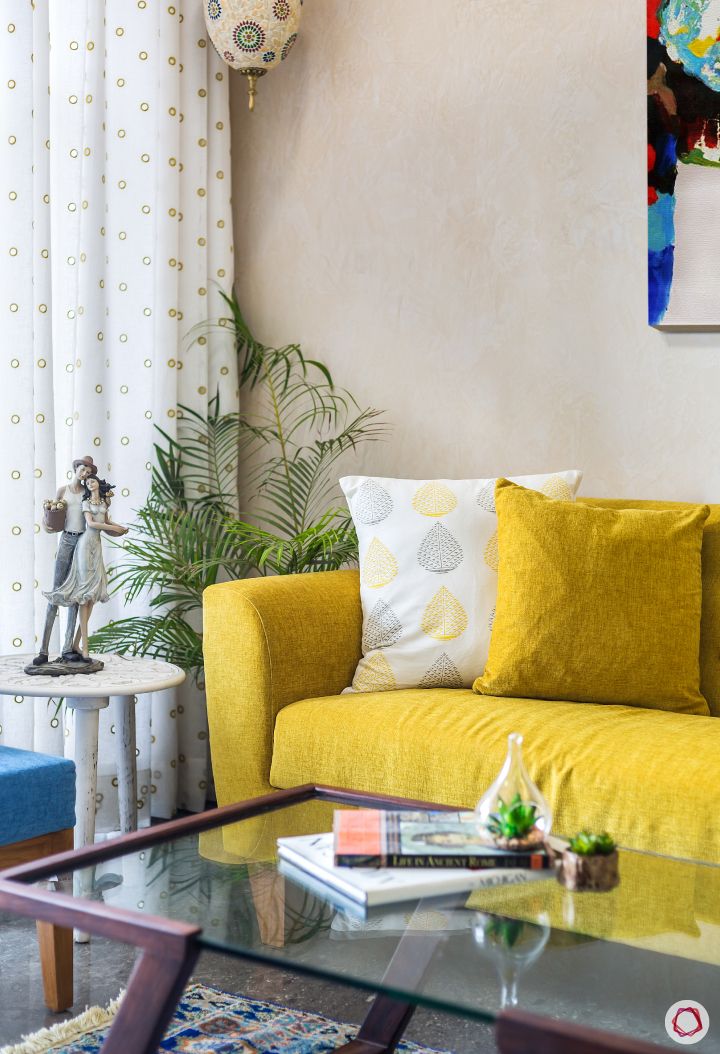 living-room-corner-sofa-yellow-accent-light-side-table-showpiece
