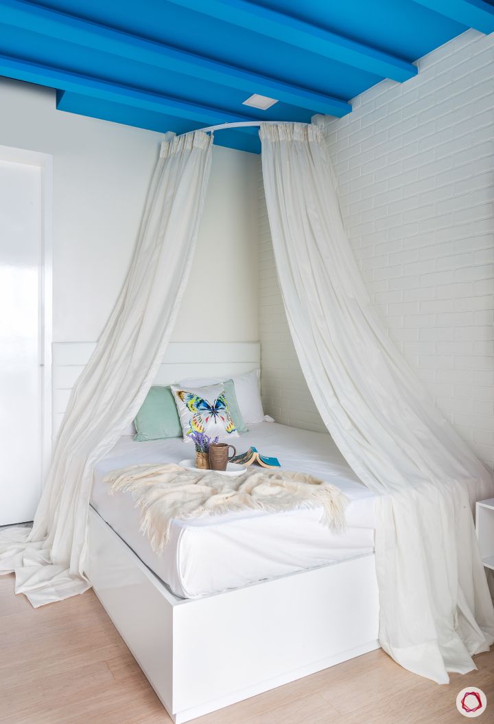daughter-bedroom-white-bed-drapes-blue-rafters
