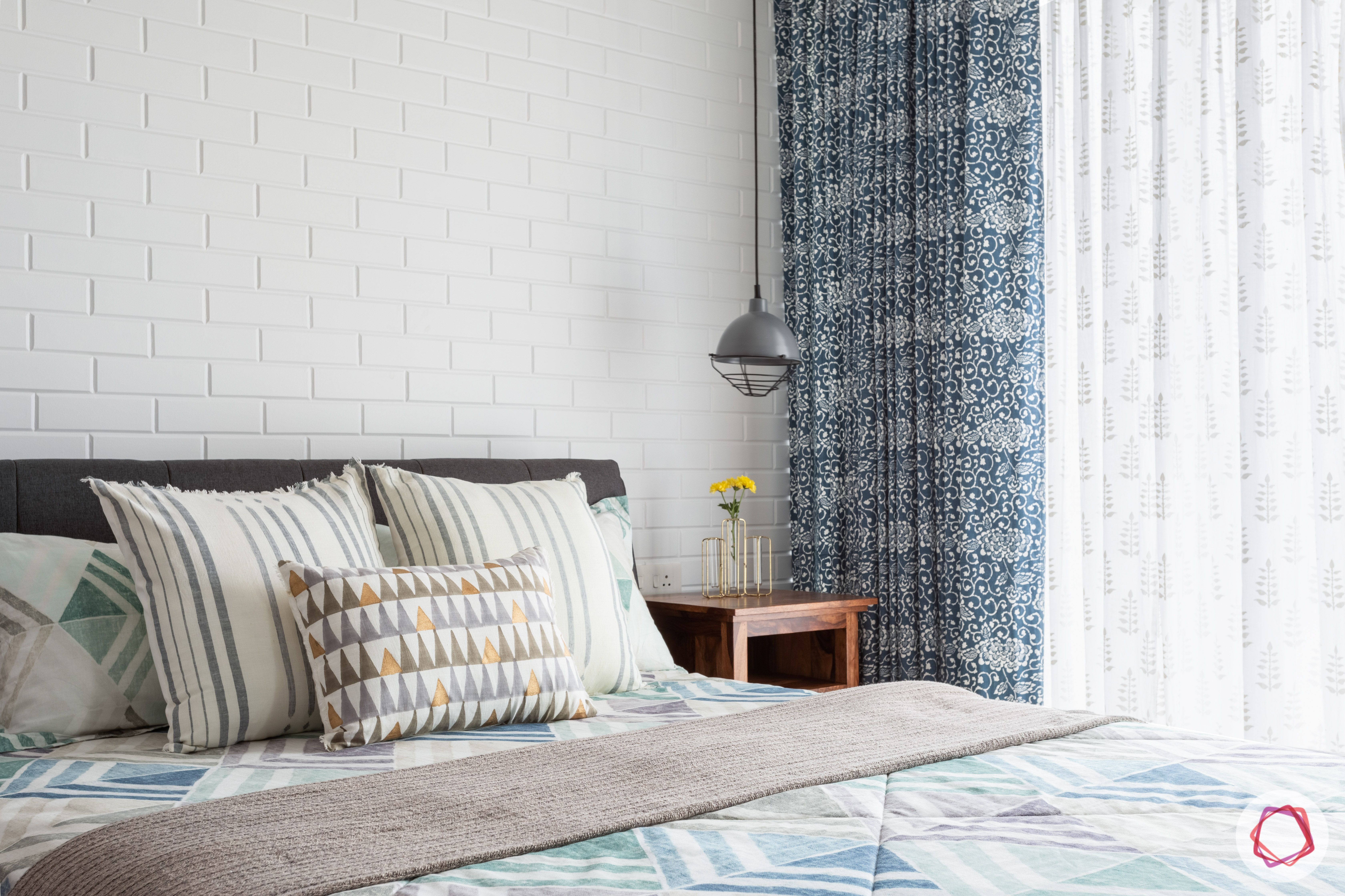 crescent bay-master bedroom-pendant lights-sheer curtains-exposed brick wall