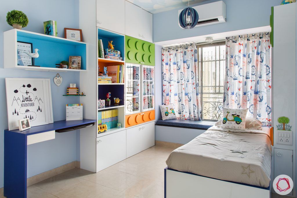 kids-room-huge-bookshelf-window-seat-blue-study-table-toys-bed 
