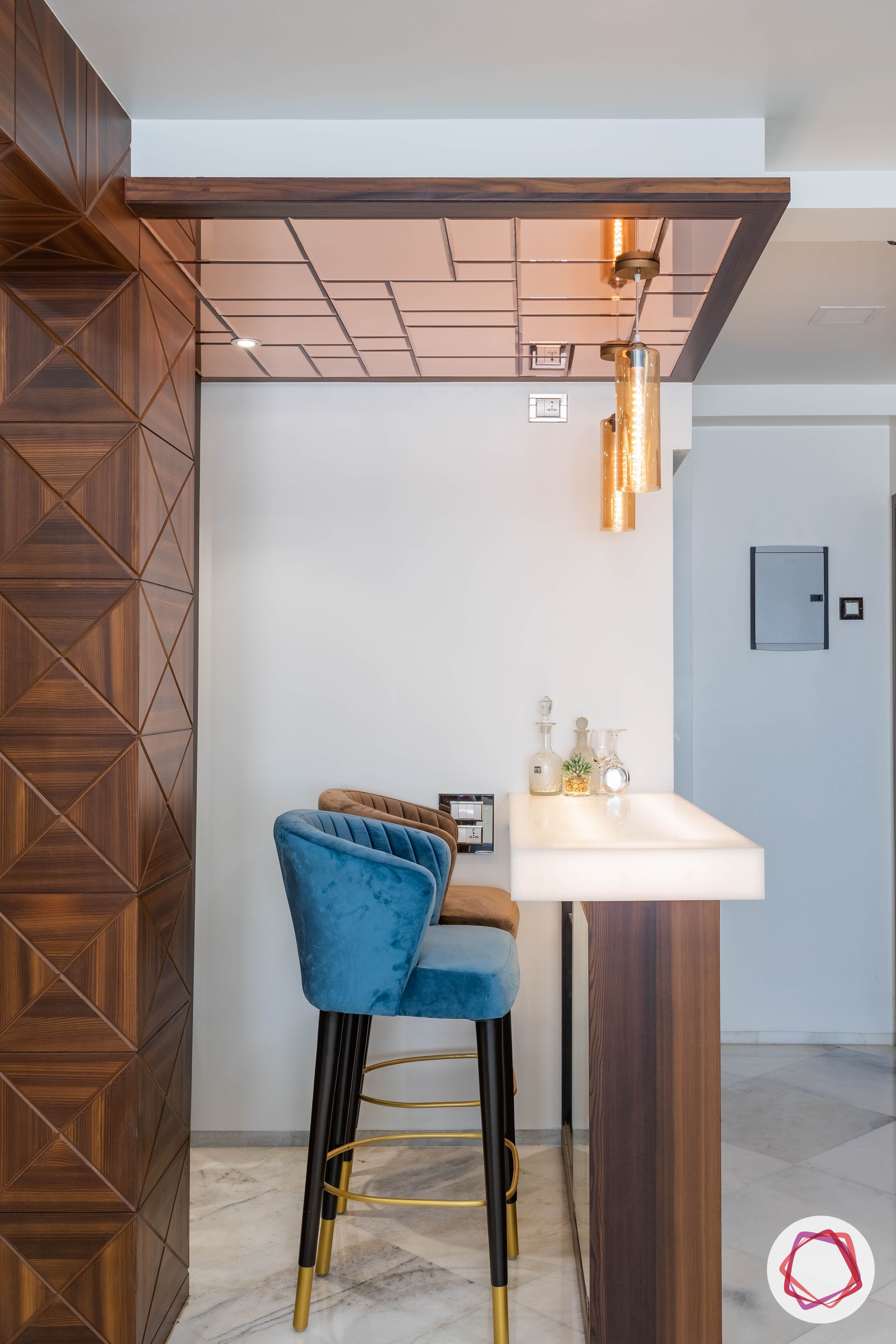 residential-interior-designers-in-mumbai-bar-blue-stool-mirror-light-table-gold
