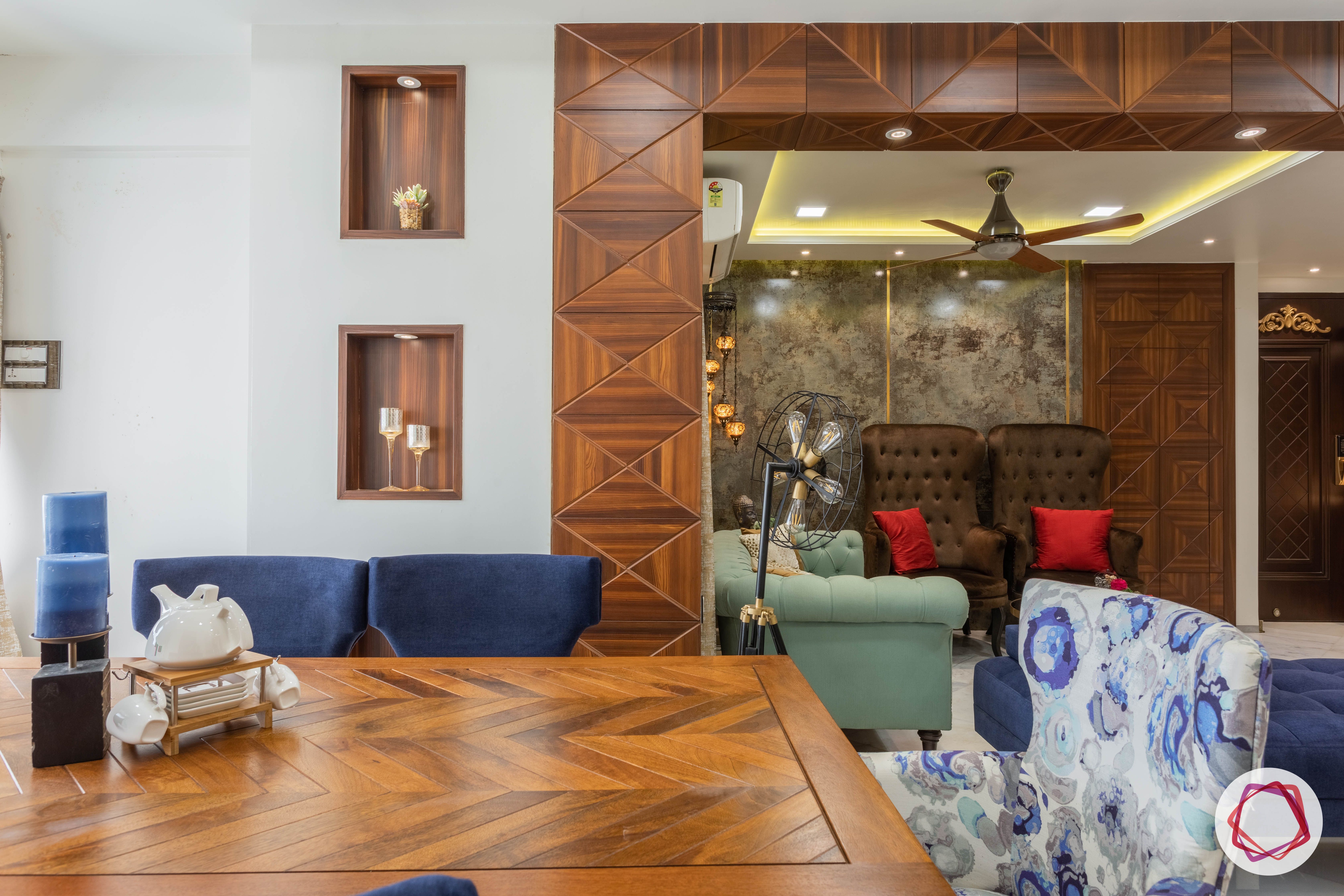 residential-interior-designers-in-mumbai-wooden-table-blue-chair-floral-candles