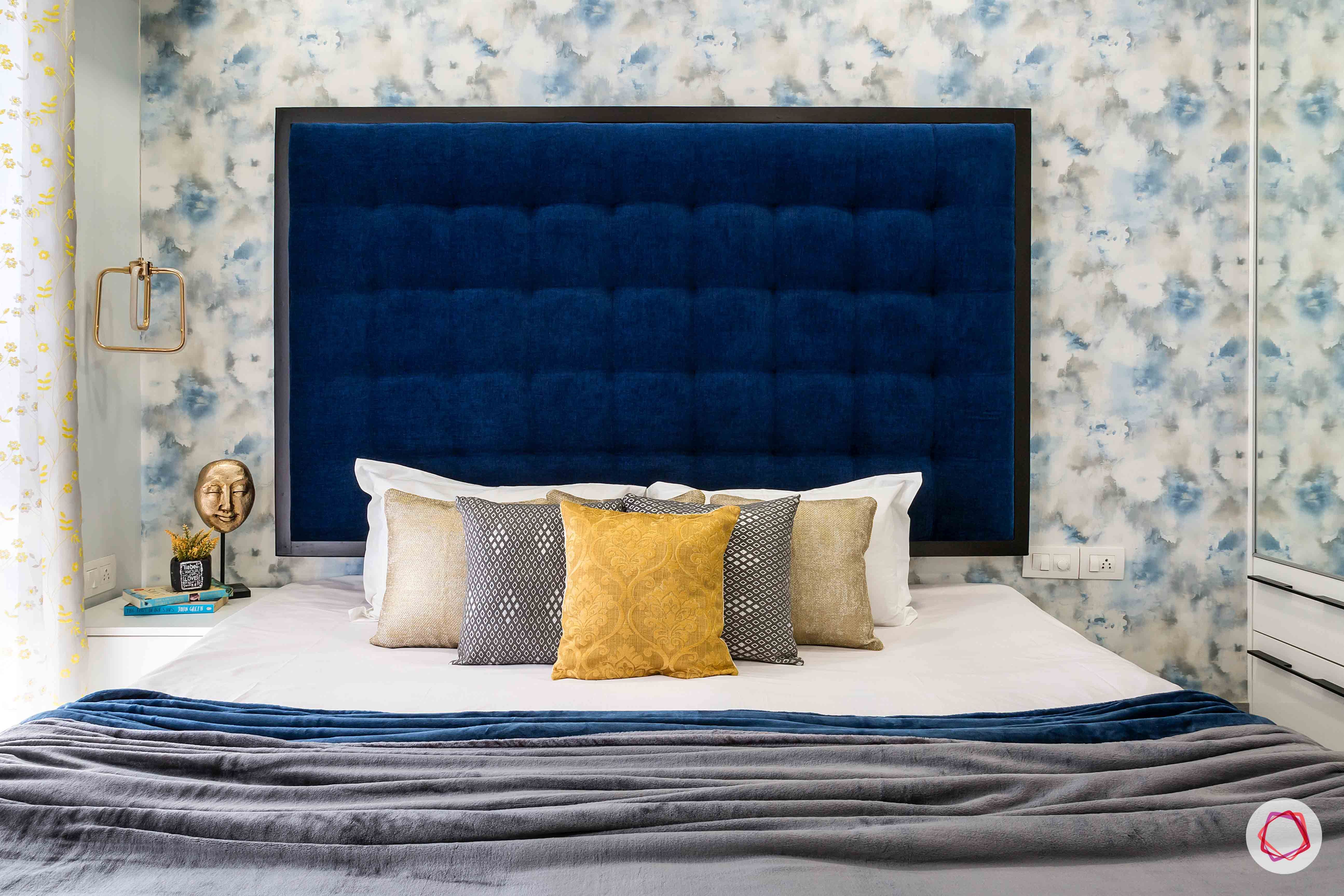 livspace-interior-bedroom-headboard-blue-wallpaper-pillows