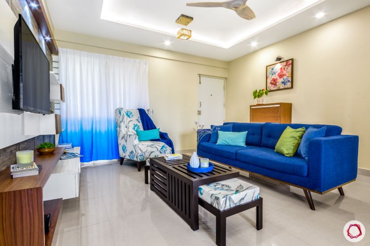 home bangalore-living room-seating area-blue sofa-cove lighting-printed accent chair