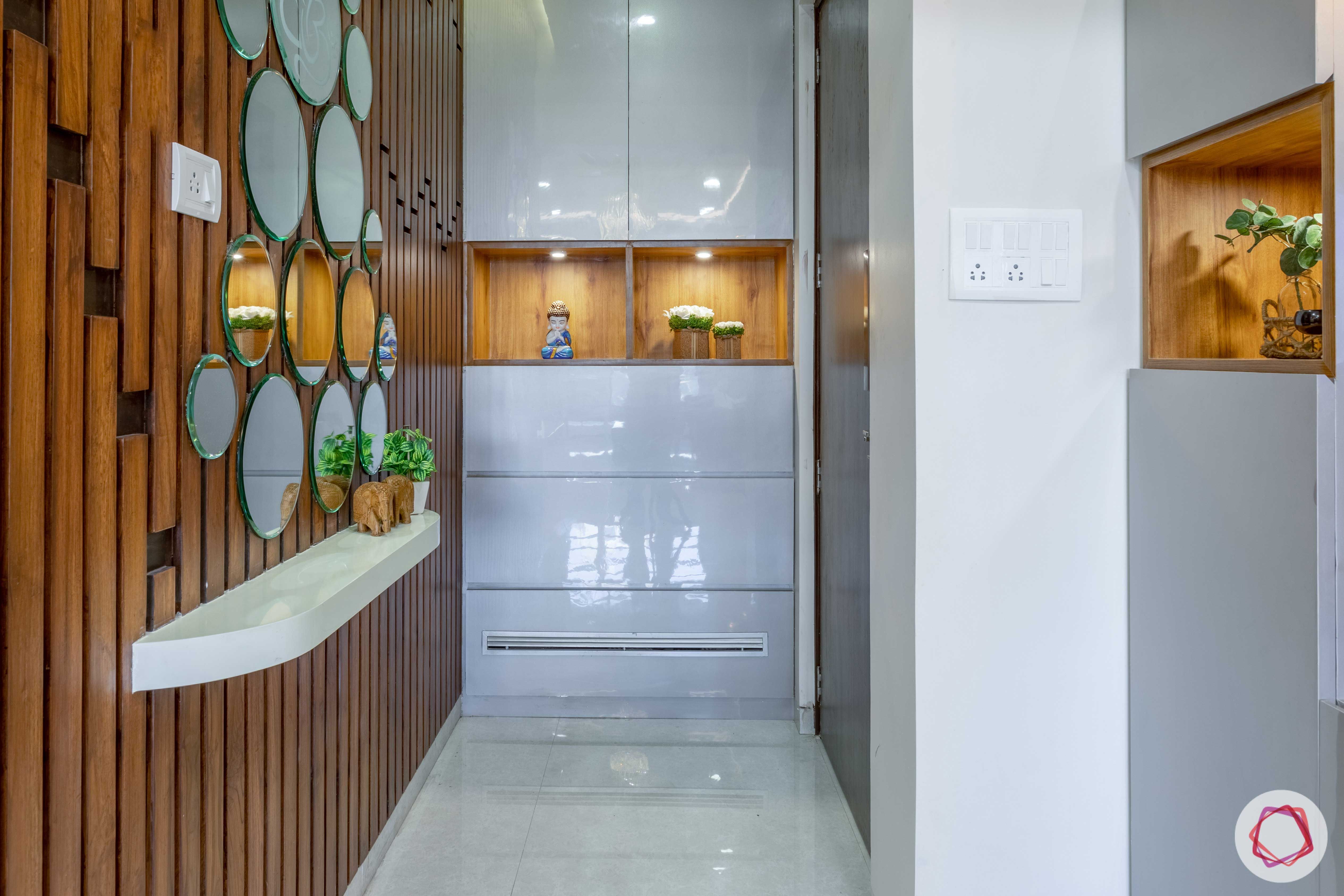 2 bhk flat interior-entrance-foyer-mirrors-wooden panels-storage-glossy finish