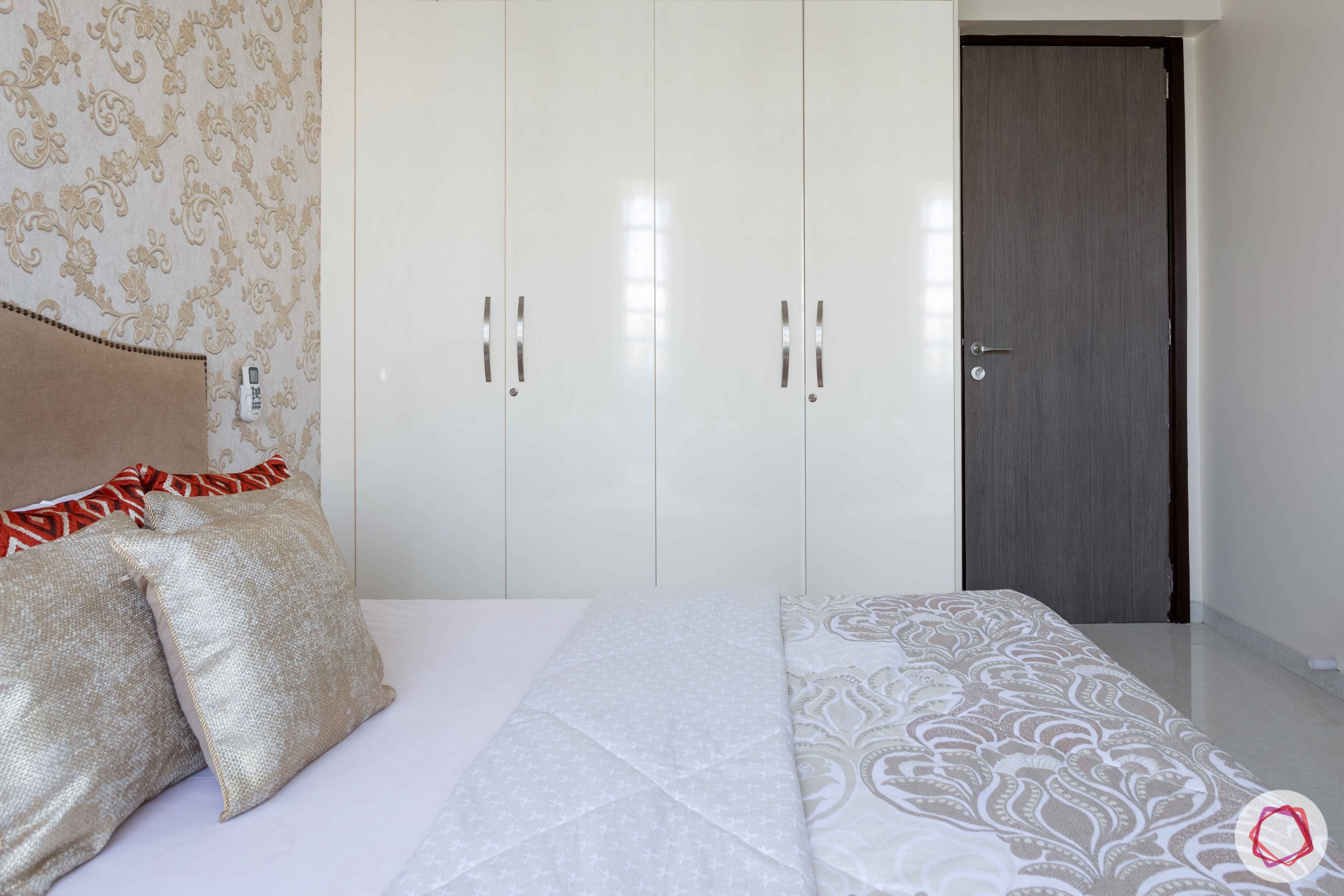2 bhk flat interior-guest bedroom-white swing door wardrobe-laminate wardrobe