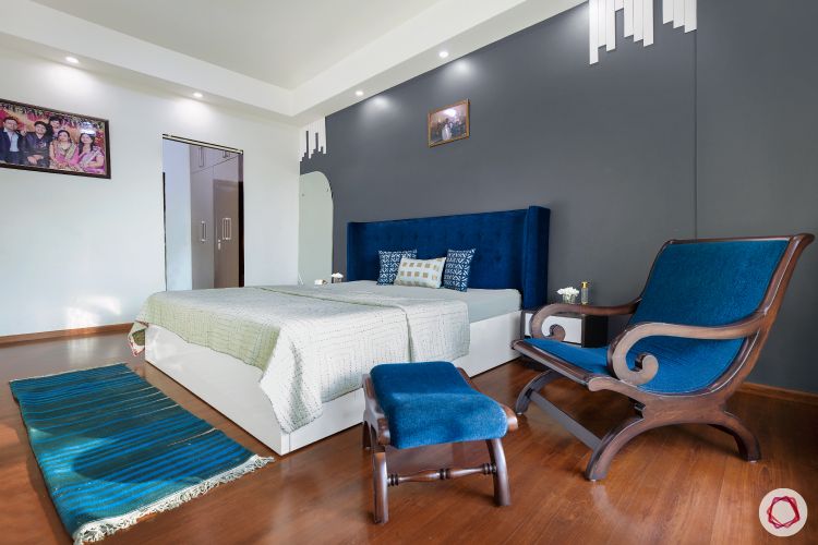 sunworld-vanalika-master-bedroom-grey-wall-wooden-flooring-blue-headboard